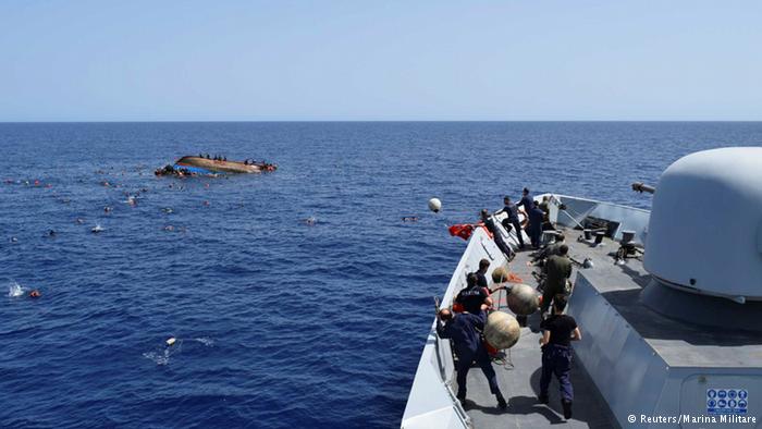 Italian navy releases dramatic images of capsized migrant boat in Mediterranean